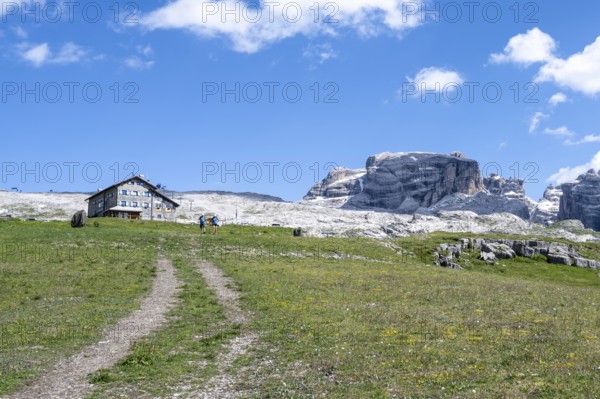 Hikers in front of Rifugio Graffer, Brenta, Brenta-Adamello Natural Park, Trentino, Italy