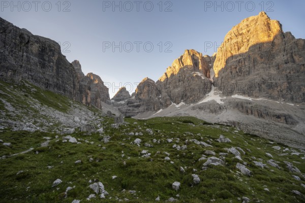Picturesque mountain landscape in Val Brenta Alta at sunrise, rocky peaks of Cima Tosa, Alpenglühen, Brenta, Trentino, Italy