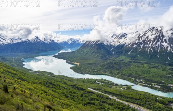 View of snowy mountains in spring and turquoise blue Kenai Lake, Slaughter Ridge Trail, Cooper Landing, Kenai Peninsula, Alaska, USA