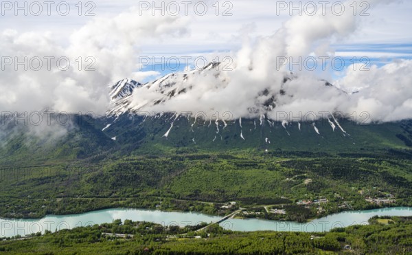 View of snowy mountains in spring and turquoise blue Kenai River, Slaughter Ridge Trail, Cooper Landing, Kenai Peninsula, Alaska, USA