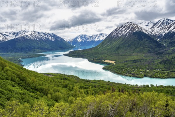 View of snowy mountains in spring and turquoise blue Kenai Lake, Slaughter Ridge Trail, Cooper Landing, Kenai Peninsula, Alaska, USA