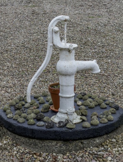 Classic hand pump for water as a decoration in a courtyard in Ystad municipality, Skåne county, Sweden, Scandinavia