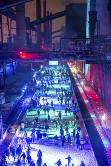 Ice rink at the Zollverein coking plant, ice skating with music and many lighting effects, Essen, North Rhine-Westphalia, Germany