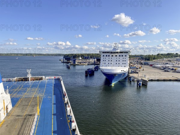 Large ferry is located in the port of Travemünde on, Scandinavia quay in the foreground dcas ceiling of an incoming TT line ferry surrounded by water and sunny skiesLübeck, Schleswig-Holstein, Germany