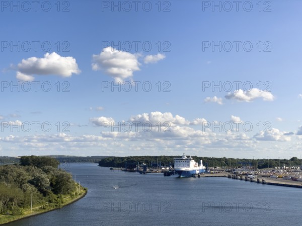 Scandinavienkai Tavemünde with large Finnlines ferry in port, surrounded by water and fluffy clouds, Travemünde, Lübeck, Schleswig-Holstein, Germany