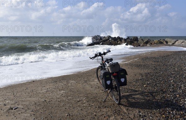 Bicycle and breakwater on the North Sea beach in Denmark
