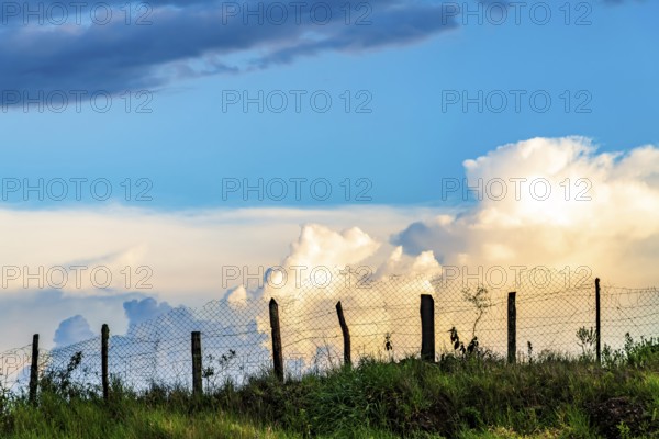 Wire fence on top of the hill during sunset on the farm, Ouro Preto, Minas Gerais, Brazil