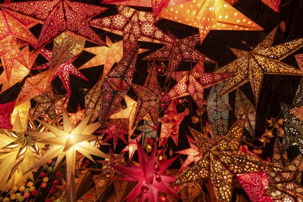 December 22, 2025, many glowing Christmas stars hanging at a market stall near St. Paul's Church, Frankfurt, Hesse, Germany