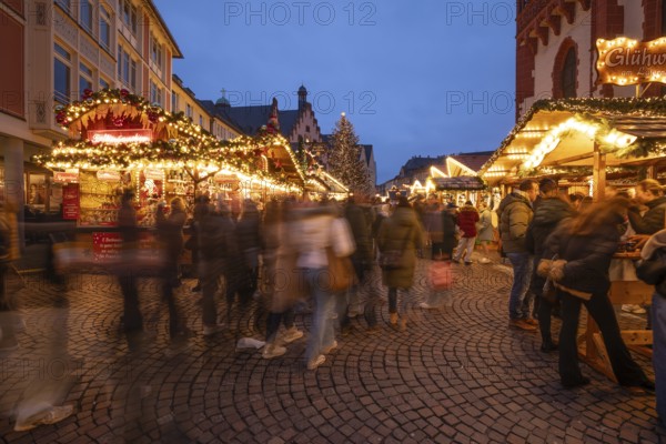 December 22, 2025, Frankfurt Christmas Market on Roemerberg at twilight. Traditional wooden stalls and festive lights shine in the historic square, Frankfurt, Hesse, Germany