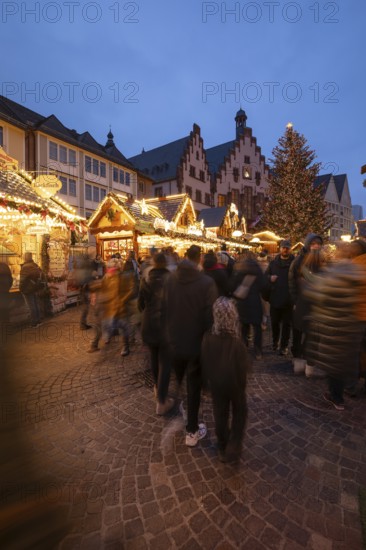 December 22, 2025, Frankfurt Christmas Market on Roemerberg at twilight. Traditional wooden stalls and festive lights shine in the historic square, Frankfurt, Hesse, Germany