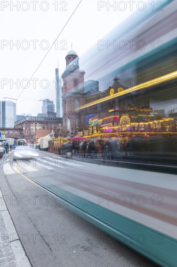 December 22, 2025, artistic long exposure showing the motion blur of a passing suburban train at the Christmas market near St. Paul's Church, Frankfurt, Hesse, Germany