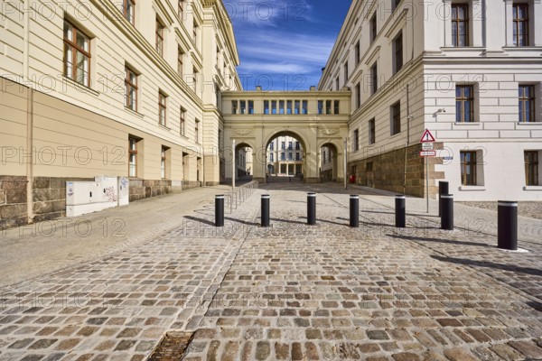 University, State Chancellery, College Building I, College Building II, Architect Carl Heinrich Wünsch, Classicism style, façade with windows, joking transition to civil service career, triumphal arch, barrier bollard, cobblestone street, blue sky, cirrus clouds, Graf-Schack-Allee intersection with Klosterstraße, Schwerin, state capital, district-free city, Mecklenburg-Western Pomerania, Germany
