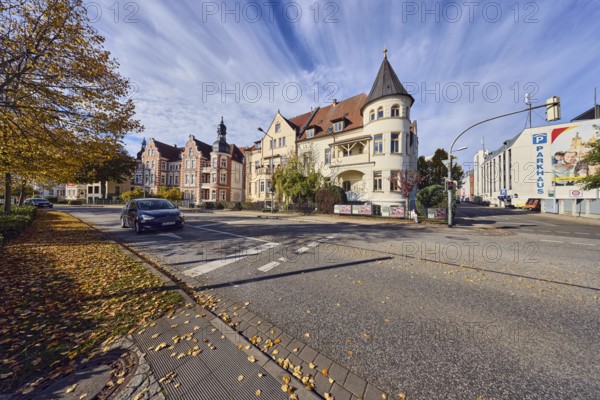Historic residential buildings, turrets, balcony, façade with windows, Contipark parking garage Am Schloss, traffic light crossing, trees with autumn leaves, fallen leaves, blue sky, cumulus clouds, intersection Graf-Schack-Allee with Geschwister-Scholl-Straße, Schwerin, state capital, district-free city, Mecklenburg-Western Pomerania, Germany
