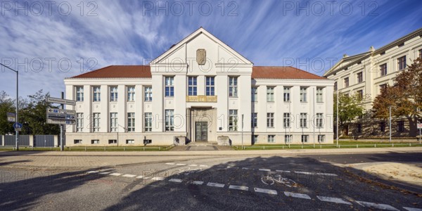 State archive, historic building, architect Paul Ehmig, central risalit, hipped roof, façade with windows and entrance, cycle path, blue sky, cirrus clouds, Graf-Schack-Allee, Schwerin, state capital, district-free city, Mecklenburg-Western Pomerania, Germany