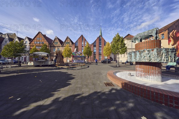 Pastor sin Kauh fountain, bronze sculpture, sculptor Stephan Horota, historic half-timbered houses, brick buildings, building material brick, trees, autumn leaves, pedestrians as accessories, blue sky, altocumulus clouds, cumulus clouds, slaughtermarket, Schwerin, state capital, district-free city, Mecklenburg-Western Pomerania, Germany
