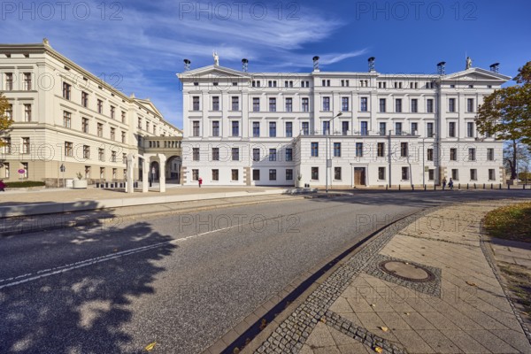 State Chancellery, former college building, architect Carl Heinrich Wünsch, architectural style classicism, façade with windows, sidewalk, street with curve, blue sky, cirrus clouds, Graf-Schack-Allee, Schwerin, state capital, district-free city, Mecklenburg-Western Pomerania, Germany