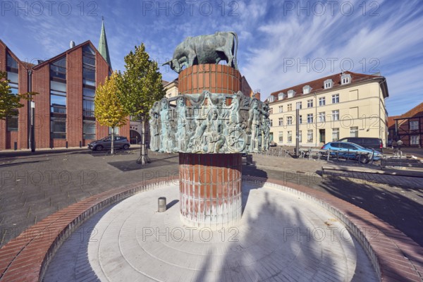 Pastor sin Kauh fountain, bronze sculpture, sculptor Stephan Horota, trees with autumn leaves, general architecture, brick buildings, houses, historic residential buildings, façade with windows, vehicles, blue sky, altocumulus clouds, cirrus clouds, Schwerin, state capital, district-free city, Mecklenburg-Western Pomerania, Germany