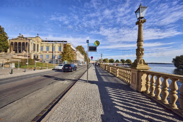 Bus stop Schwerin Castle - Theatre, Schwerin State Museum, renovation, art museum, lantern, sandstone railing, shade of railing, barrier bollard, paving stone sidewalk, street, car, lake Schweriner Innensee, blue sky, altocumulus clouds, Werderstraße, Schwerin, state capital, district-free city, Mecklenburg-Western Pomerania, Germany