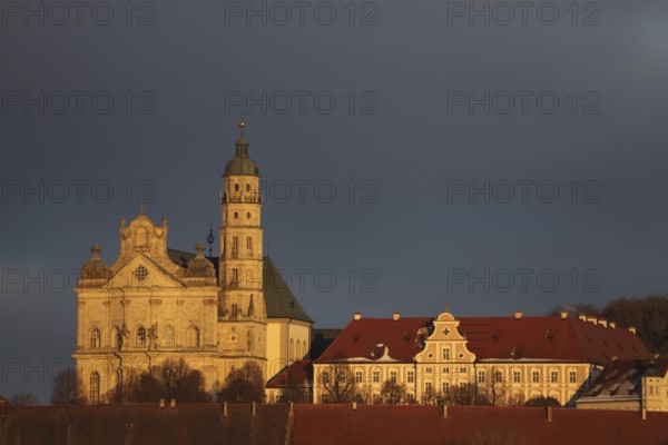 Benedictine monastery with late baroque monastery church, lighting atmosphere, winter, Neresheim, Härtsfeld, Swabian Jura, Baden-Württemberg, Germany