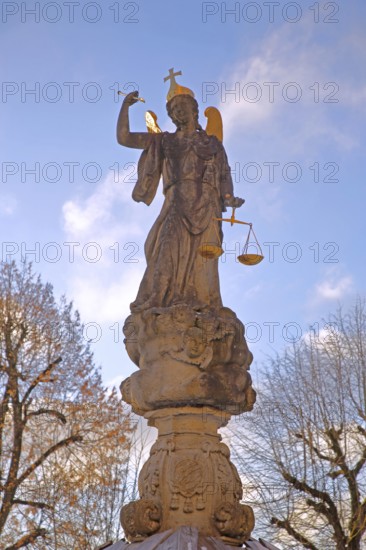 Justice as an angel and golden crown with cross, and beam scale, golden wings, symbol of justice and law, stone sculpture, cutout, courtyard, Benedictine monastery, Neresheim, Härtsfeld, Swabian Jura, Baden-Württemberg, Germany