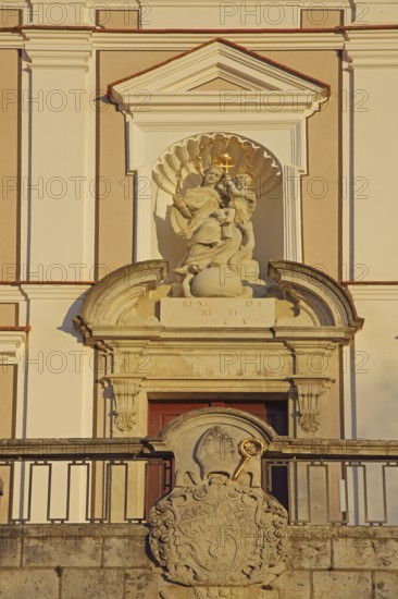 Portal with coat of arms and Madonna figure at the Benedictine monastery, Neresheim, Härtsfeld, Swabian Jura, Baden-Württemberg, Germany