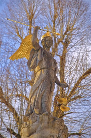 Justice as an angel and golden crown with cross and beam scale, golden wings, symbol of justice and law, stone sculpture, cutout, courtyard, Benedictine monastery, Neresheim, Härtsfeld, Swabian Jura, Baden-Württemberg, Germany