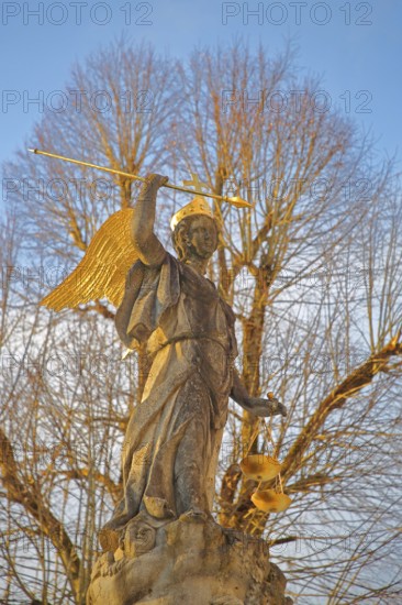 Justice as an angel and golden crown with cross, spear and beam scale, golden wings, symbol of justice and law, stone sculpture, courtyard, Benedictine monastery, Neresheim, Härtsfeld, Swabian Jura, Baden-Württemberg, Germany