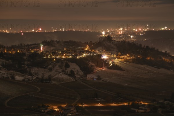 New Year's Eve view from Kapellberg near Fellbach towards Rotenberg. View of the grave chapel in Württemberg as fireworks rockets and firecrackers illuminate the night sky over Stuttgart on New Year's Eve from 2025 on 2026 at the turn of the year