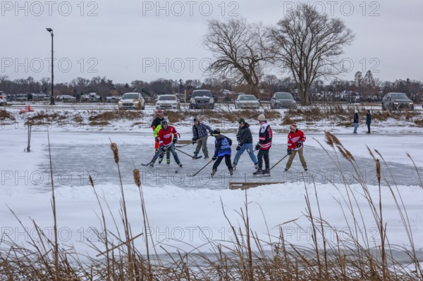 Detroit, Michigan USA - 1 January 2026 - As temperatures dropped and snow fell in the Great Lakes region, people shoveled ice off Lake Okonoka in Belle Isle State Park to play ice hockey on New Year's Day