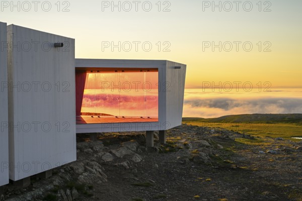 Windbreaks and observation huts on Mount Domen. The project consists of three small buildings, which are arranged in such a way that they always protect against wind and weather, and the reddish color protects birds from impact. Biotope Architectural Office. Domen, Vardö, Finnmark, Norway
