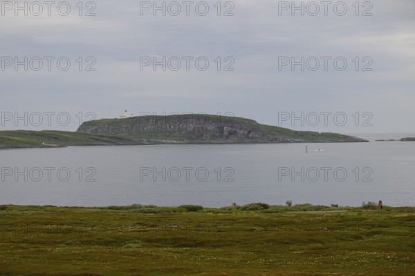 View of Reinoya and Hornoya islands from Vardö. The Vardö lighthouse can be seen on Hornoya. Vardø, Finnmark, Norway