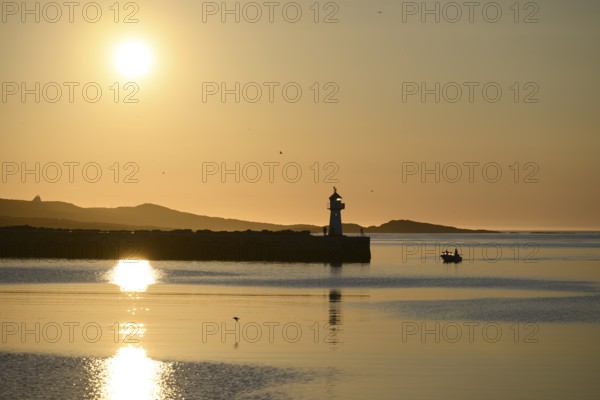 Harbour entrance with lighthouse and midnight sun, Vardø, Finnmark, Norway