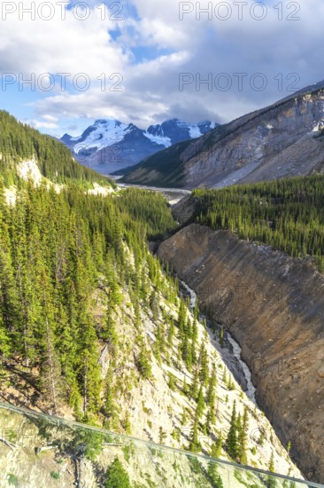 Breathtaking view from the glass floored skywalk extending over the sunwapta valley, revealing the athabasca glacier and surrounding peaks in the canadian rockies of jasper national park, alberta