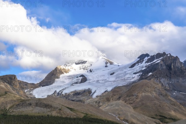 Athabasca glacier is melting under a cloudy sky, showing the effects of climate change on the columbia icefield in jasper national park, alberta, canada
