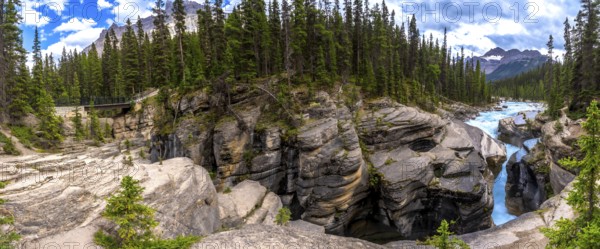 Mistaya canyon, showcasing the stunning artistry of erosion on rock formations in banff national park, alberta, canada, captivates beneath a vibrant sky