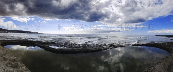 Broad view of a coastal landscape with cloud reflection in the water, Los Cristianos, Tenerife