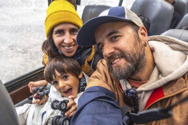 Happy family taking a selfie on a large ice explorer bus while visiting the athabasca glacier of the columbia icefield in jasper national park in alberta, canada