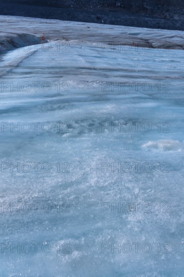 Ice formations of the athabasca glacier in jasper national park, alberta, canada, are melting due to global warming, creating a stunning yet concerning visual of climate change impact