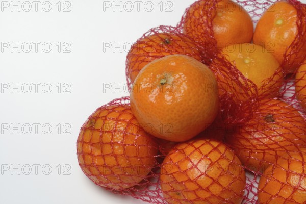 Clementines in a net, tropical fruit