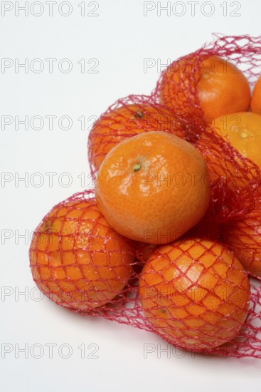 Clementines in a net, tropical fruit