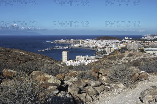 Hill view of the tourist town of Los Cristianos and the blue sea on a sunny day, Los Cristianos Tenerife
