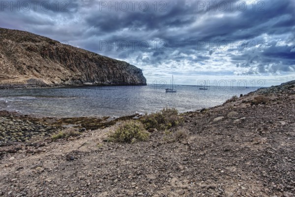 View of boats in coastal waters under dramatic skies, Los Cristianos Tenerife