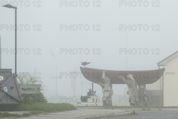 Fishermen carrying a rowboat in fog sculpture, Vardø, Finnmark, Norway