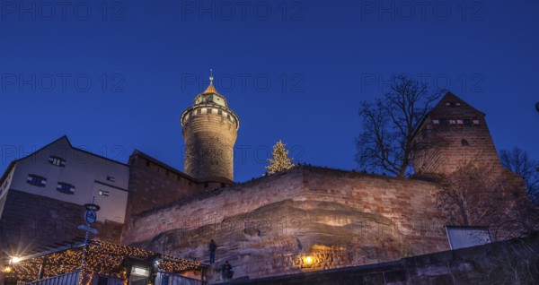 Illuminated Sinwell Tower, built in the 13th century, in the evening sky, Kaiserburg, Nuremberg, Middle Franconia, Bavaria, Germany