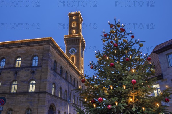 Fürth Town Hall in evening lighting, the tower is imitated the tower of the Palazzo Vecchio in Florence, on the right a decorated Christmas tree, blue evening sky, Fürth, Middle Franconia, Bavaria, Germany
