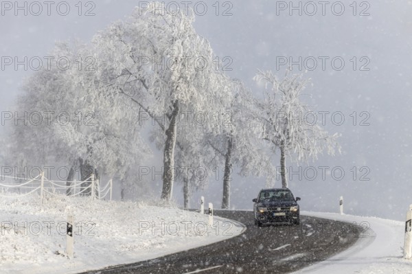 Winter in the Swabian Jura. Country road with snowy landscape near Westerheim, Alb-Donau-Kreis, Baden-Württemberg, Germany