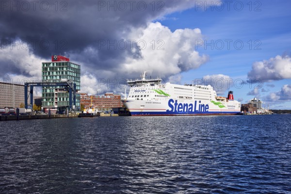Kiel Fjord, Stena Germanica ferry, Stena Line GmbH, ferry, port house, high-rise building, modern architecture, general development, port, wharf, portal crane, seaport Kiel GmbH and Co. KG, water surface with small waves, blue sky, cumulus clouds, stratocumulus clouds, white and dark clouds, Kiel, state capital, district-free city, Schleswig-Holstein, Germany
