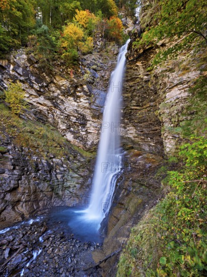 Diesbach waterfall in autumn-colored surroundings, Linthal, Klausenpass, Canton of Glarus, Switzerland