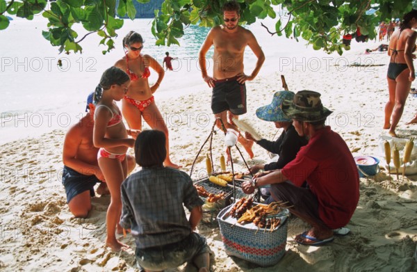Woman with food store and customers on Pranang Cave beach, two years in front of the tsunami, Krabi, Thailand, December 2002, vintage, retro, old, historic