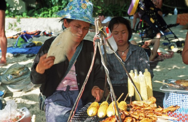 Woman and daughter with food stash on Pranang Cave beach, two years in front of the tsunami, Krabi, Thailand, December 2002, vintage, retro, old, historic